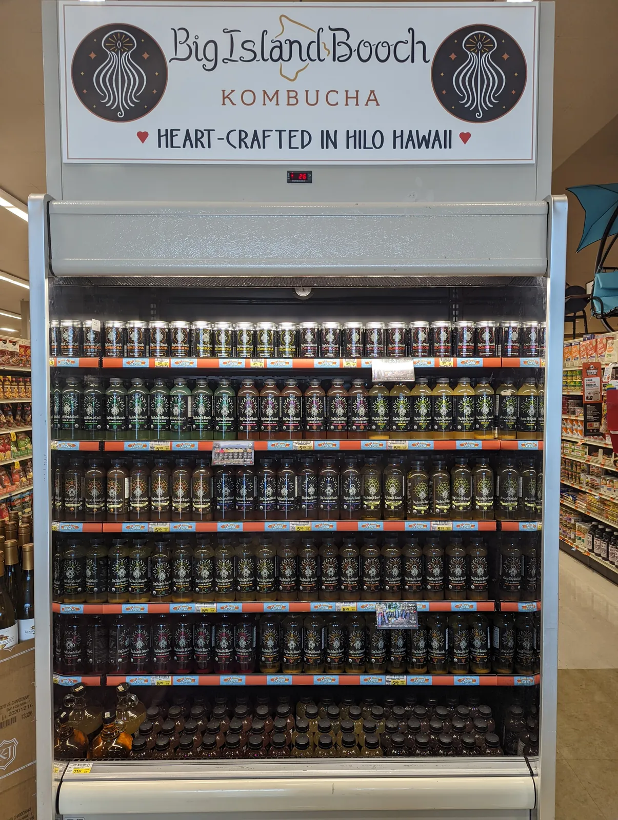 A Big Island Booch branded retail cooler headed Heart-Crafted in Hilo Hawaii, fully stocked with bottles.
