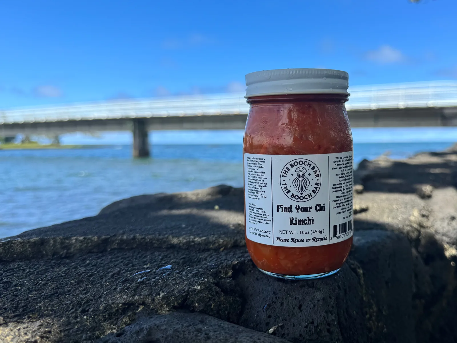 A 16 oz jar of Big Island Booch Find Your Chi kimchi on lava rock at Hilo Bay